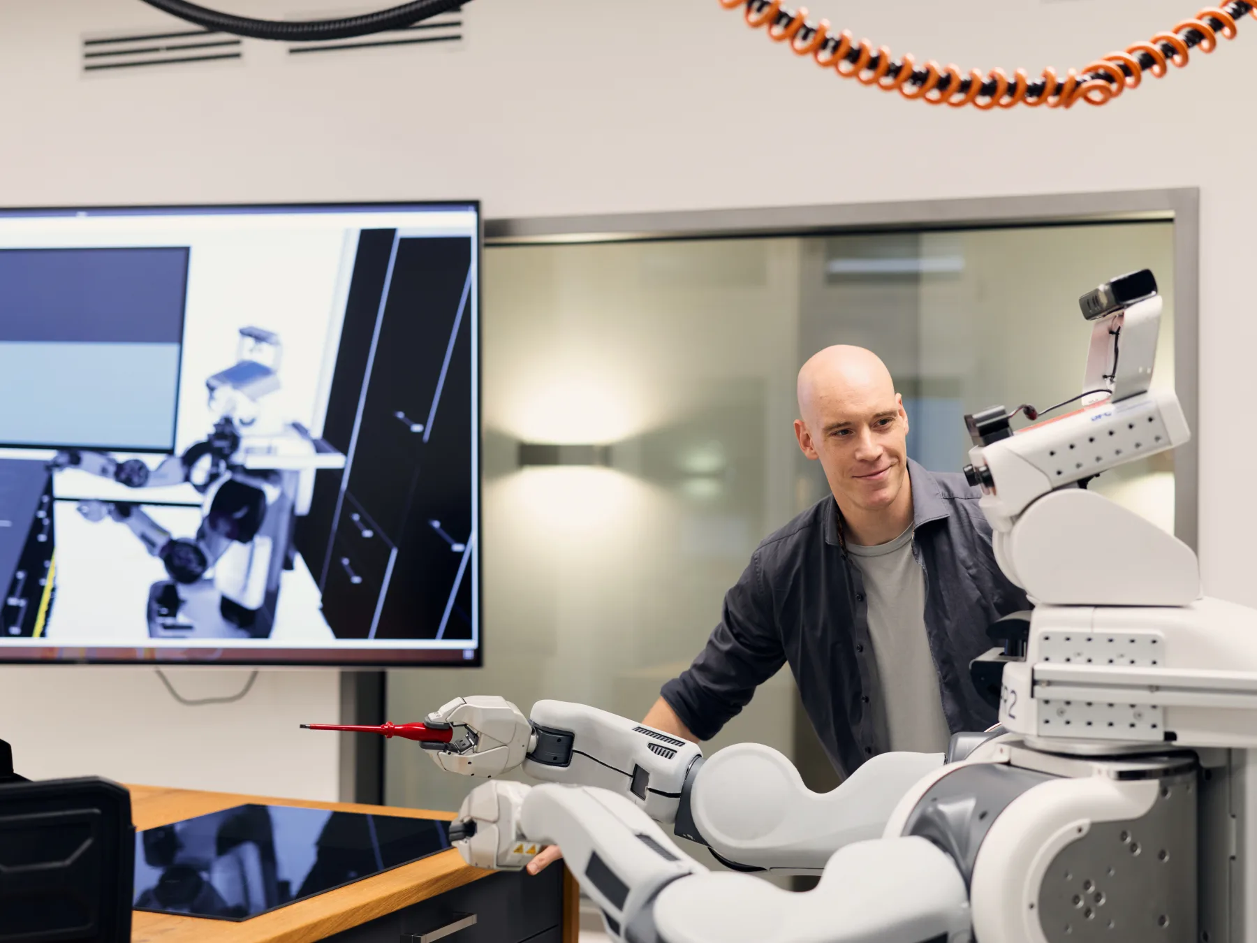 A researcher working with a PR2 robot during a manipulation test